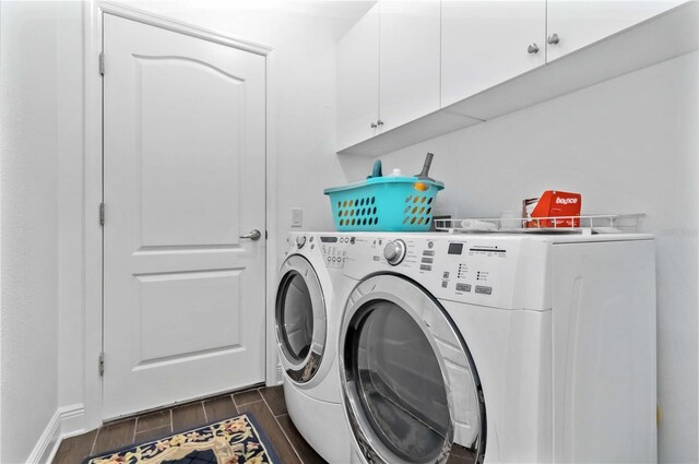 10926 Sand Pine Ln, Parrish, FL 34219 - laundry room featuring cabinet space, wood finish floors, washer and dryer, and baseboards
