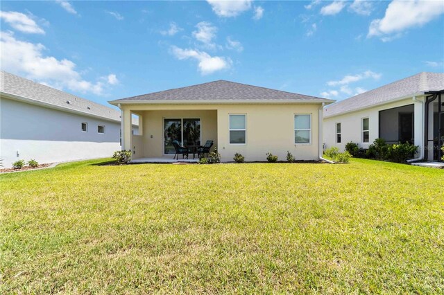 10926 Sand Pine Ln, Parrish, FL 34219 - back of property with a lawn, a patio area, and stucco siding