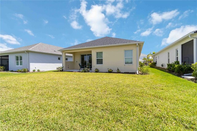 10926 Sand Pine Ln, Parrish, FL 34219 - back of property featuring a yard and stucco siding