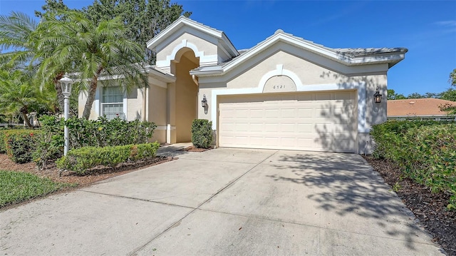 6721 Oak Manor Dr, Lakewood Ranch, FL 34202 - view of front of home with concrete driveway, a garage, and stucco siding