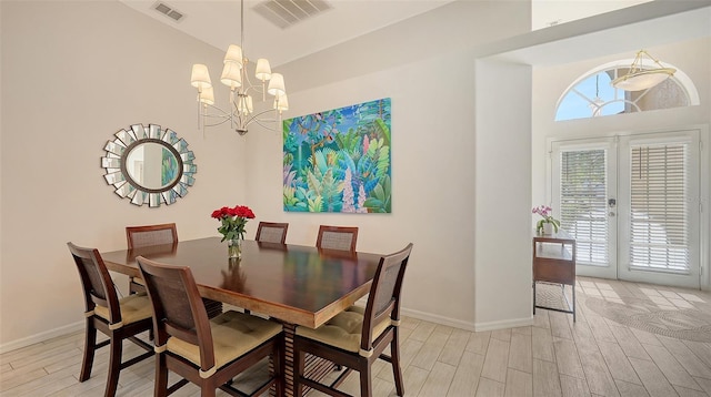 6721 Oak Manor Dr, Lakewood Ranch, FL 34202 - dining room featuring wood tiled floors, a chandelier, baseboards, french doors, and vaulted ceiling