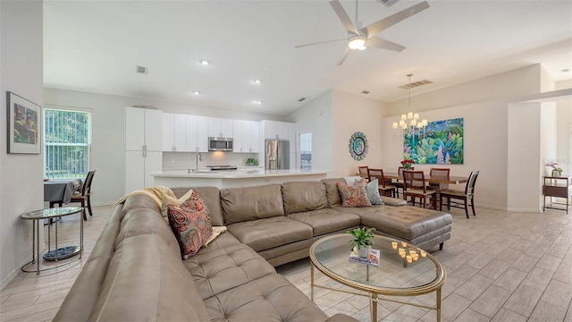 6721 Oak Manor Dr, Lakewood Ranch, FL 34202 - living area featuring baseboards, a chandelier, ceiling fan, light wood-style floors, and high vaulted ceiling