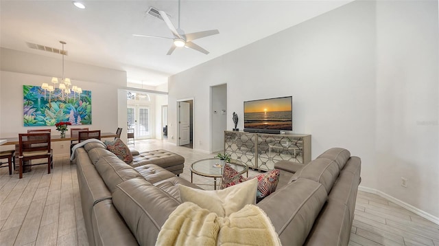 6721 Oak Manor Dr, Lakewood Ranch, FL 34202 - living area featuring a chandelier, a ceiling fan, light wood-style floors, baseboards, and a high ceiling
