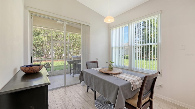 6721 Oak Manor Dr, Lakewood Ranch, FL 34202 - dining area featuring light wood-style flooring, plenty of natural light, vaulted ceiling, and baseboards