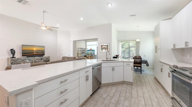 6721 Oak Manor Dr, Lakewood Ranch, FL 34202 - kitchen with appliances with stainless steel finishes, a sink, open floor plan, light countertops, and white cabinetry