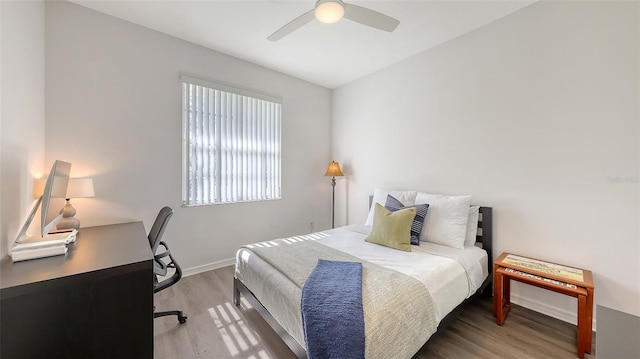 6721 Oak Manor Dr, Lakewood Ranch, FL 34202 - bedroom with wood finished floors, a desk, baseboards, and a ceiling fan