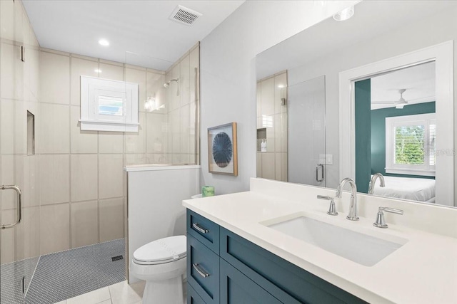 bathroom with a stall shower, toilet, ensuite bathroom, and tile patterned floors