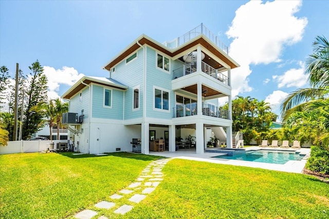 rear view of house with a balcony, stairway, a patio, and central AC