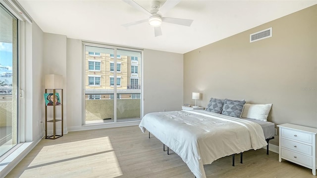 800 N Tamiami Trl Unit 317, Sarasota, FL 34236 - bedroom with light wood-style flooring, baseboards, and a ceiling fan