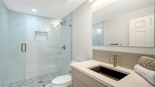 800 N Tamiami Trl Unit 317, Sarasota, FL 34236 - bathroom featuring a stall shower, toilet, tasteful backsplash, vanity, and recessed lighting