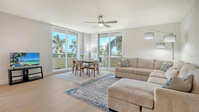 800 N Tamiami Trl Unit 317, Sarasota, FL 34236 - living area with ceiling fan, light wood-type flooring, and baseboards
