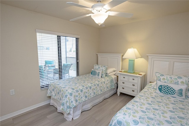 bedroom featuring light wood-style flooring, baseboards, and ceiling fan