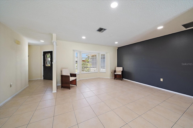 3335 Meadow Run Ter, Venice, FL 34293 - empty room with recessed lighting, a textured ceiling, light tile patterned floors, and baseboards