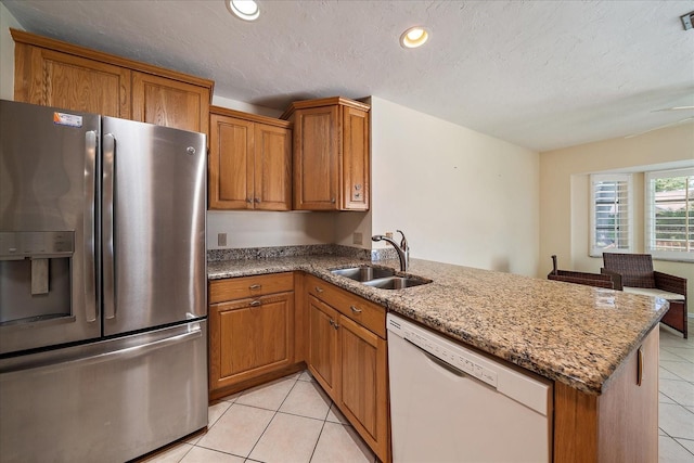3335 Meadow Run Ter, Venice, FL 34293 - kitchen featuring stainless steel fridge, dishwasher, a sink, a peninsula, and light tile patterned flooring