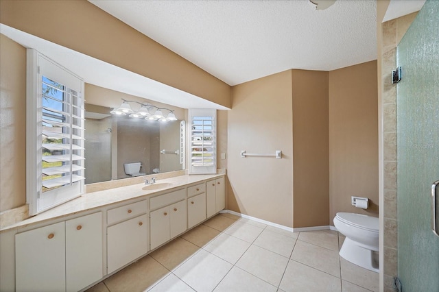 3335 Meadow Run Ter, Venice, FL 34293 - full bath with toilet, tile patterned flooring, vanity, a shower with shower door, and baseboards