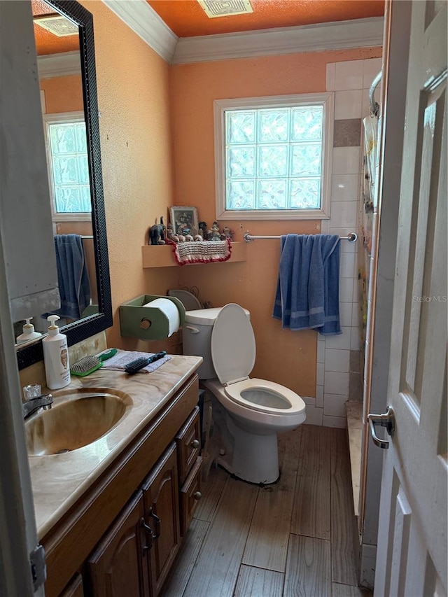 3720 27th St E, Bradenton, FL 34208 - bathroom with ornamental molding, wood finished floors, toilet, vanity, and curtained shower