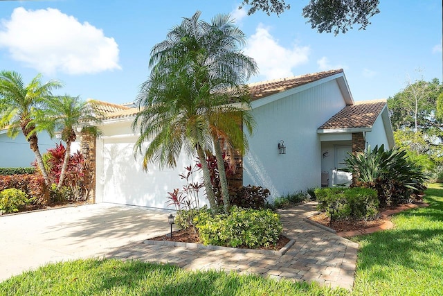 5812 Garden Lakes Fern, Bradenton, FL 34203 - mediterranean / spanish-style home featuring an attached garage, stucco siding, concrete driveway, and a tiled roof