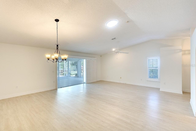 5812 Garden Lakes Fern, Bradenton, FL 34203 - unfurnished room featuring a textured ceiling, vaulted ceiling, light wood finished floors, ceiling fan, and a chandelier