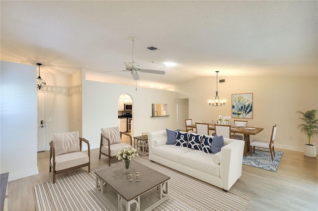 5812 Garden Lakes Fern, Bradenton, FL 34203 - living area with light wood-style flooring, a ceiling fan, baseboards, vaulted ceiling, and a chandelier