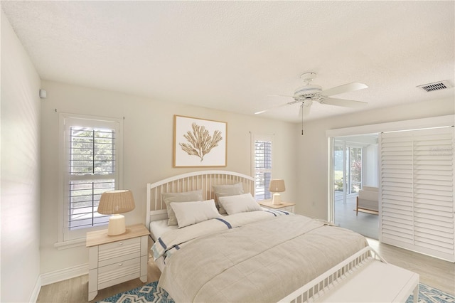 5812 Garden Lakes Fern, Bradenton, FL 34203 - bedroom featuring light wood-style flooring, baseboards, a textured ceiling, and ceiling fan