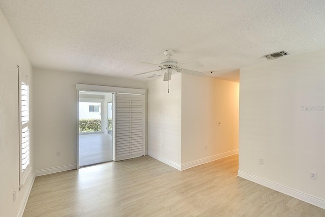 5812 Garden Lakes Fern, Bradenton, FL 34203 - spare room featuring a textured ceiling, light wood-style flooring, a ceiling fan, and baseboards