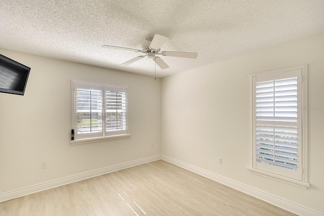 5812 Garden Lakes Fern, Bradenton, FL 34203 - spare room featuring wood finished floors, a textured ceiling, a ceiling fan, and baseboards