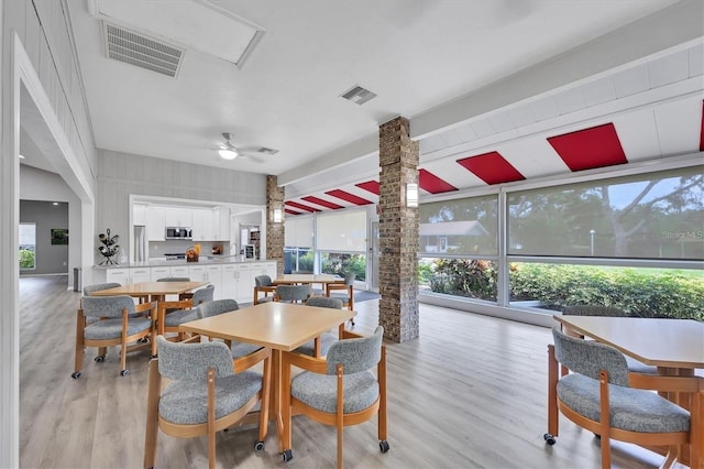 5812 Garden Lakes Fern, Bradenton, FL 34203 - dining area featuring ornate columns, light wood-type flooring, a ceiling fan, and beam ceiling