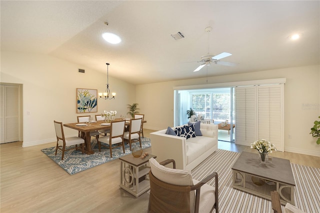 5812 Garden Lakes Fern, Bradenton, FL 34203 - living room with lofted ceiling, light wood finished floors, baseboards, a ceiling fan, and a chandelier