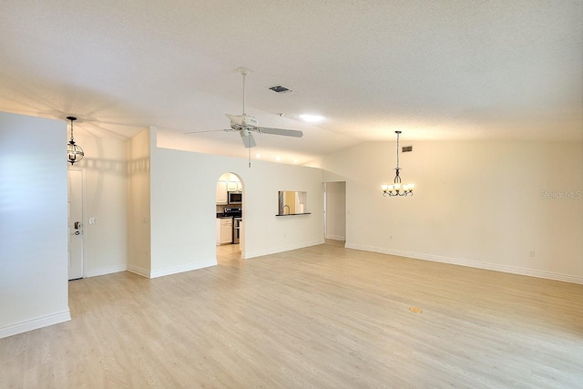 5812 Garden Lakes Fern, Bradenton, FL 34203 - unfurnished living room with a ceiling fan, light wood-style floors, a chandelier, baseboards, and lofted ceiling