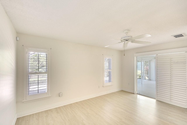 5812 Garden Lakes Fern, Bradenton, FL 34203 - unfurnished room featuring light wood-type flooring, a textured ceiling, ceiling fan, and baseboards