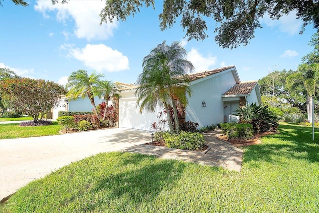 5812 Garden Lakes Fern, Bradenton, FL 34203 - mediterranean / spanish home with a tile roof, a garage, concrete driveway, a front lawn, and stucco siding