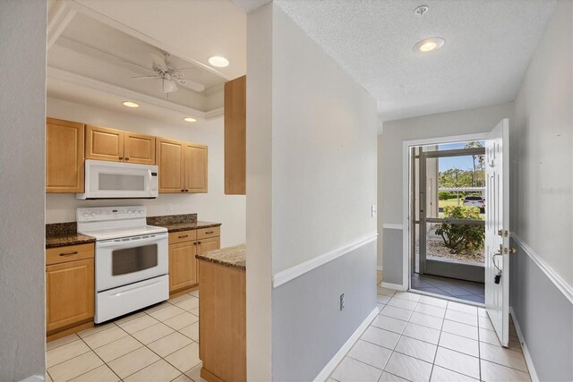 8755 Olde Hickory Ave Unit 7105, Sarasota, FL 34238 - kitchen featuring white appliances, light tile patterned flooring, baseboards, recessed lighting, and dark stone counters