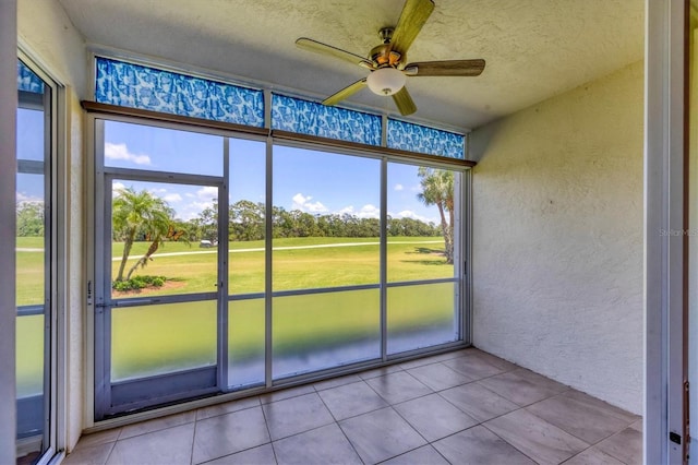 8755 Olde Hickory Ave Unit 7105, Sarasota, FL 34238 - unfurnished sunroom featuring a ceiling fan, view of golf course, and view of scattered trees