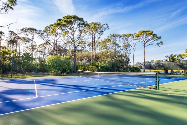 8755 Olde Hickory Ave Unit 7105, Sarasota, FL 34238 - view of tennis court with fence, community basketball court, and view of wooded area