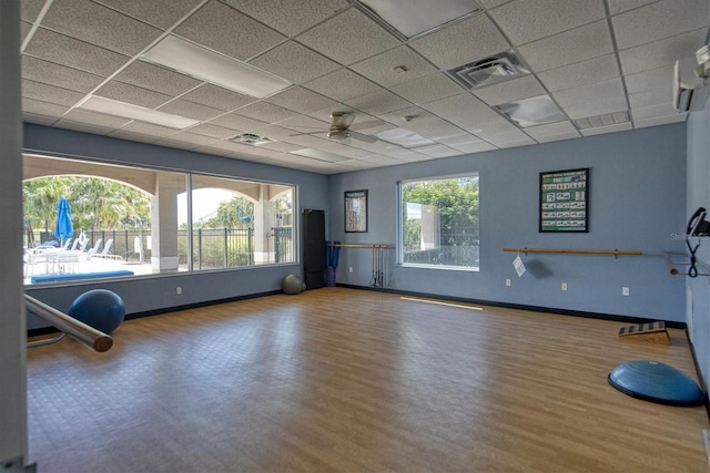 8755 Olde Hickory Ave Unit 7105, Sarasota, FL 34238 - exercise area featuring wood finished floors, a paneled ceiling, baseboards, and ceiling fan