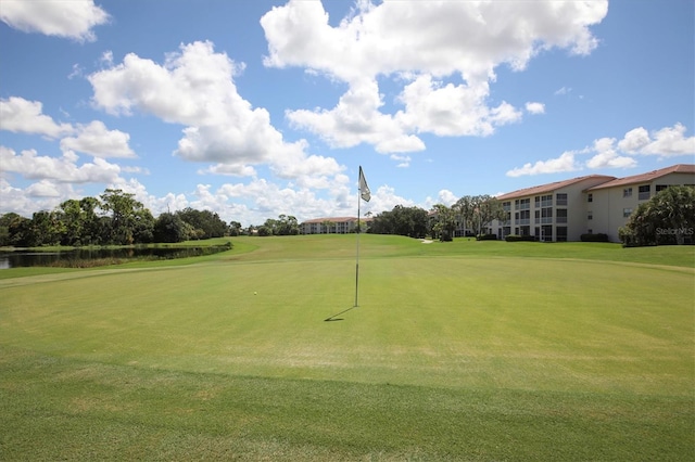 8755 Olde Hickory Ave Unit 7105, Sarasota, FL 34238 - surrounding community with golf course view, a water view, a yard, and an area to practice putting