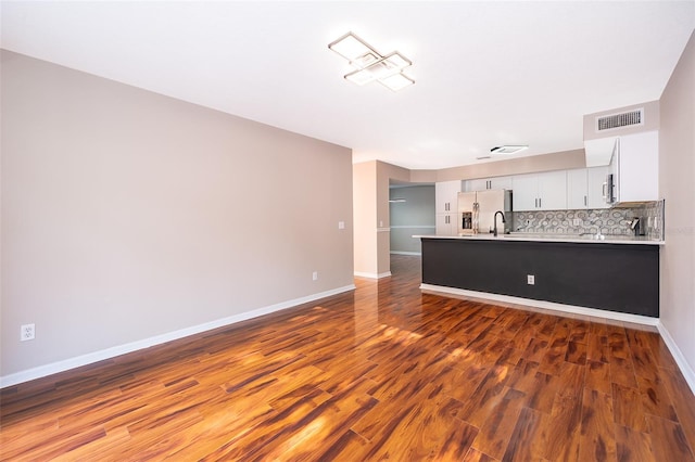 1839 Cranberry Isles Way, Apopka, FL 32712 - unfurnished living room featuring baseboards, wood finished floors, and a sink