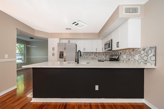 1839 Cranberry Isles Way, Apopka, FL 32712 - kitchen featuring appliances with stainless steel finishes, a sink, a peninsula, light countertops, and white cabinetry