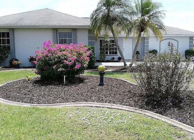 2178 Calcutta Rd, Punta Gorda, FL 33983 - view of front of home with stucco siding and a front yard