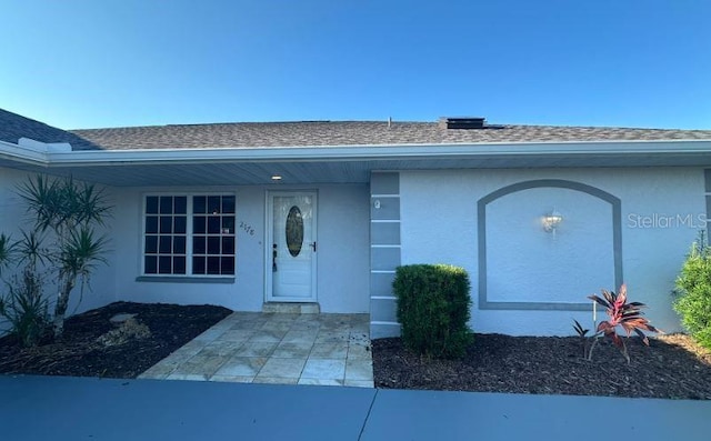 2178 Calcutta Rd, Punta Gorda, FL 33983 - doorway to property with stucco siding and roof with shingles