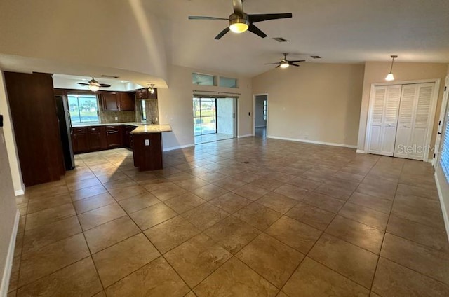 2178 Calcutta Rd, Punta Gorda, FL 33983 - unfurnished living room featuring a ceiling fan, baseboards, light tile patterned flooring, and high vaulted ceiling