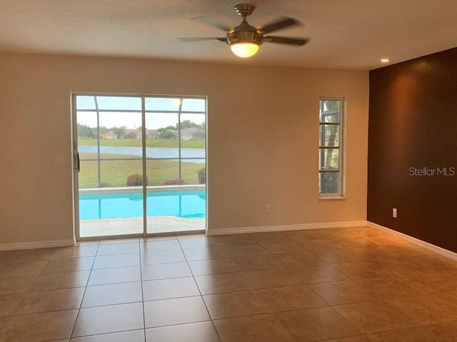 2178 Calcutta Rd, Punta Gorda, FL 33983 - tiled spare room featuring healthy amount of natural light, a water view, a ceiling fan, and baseboards