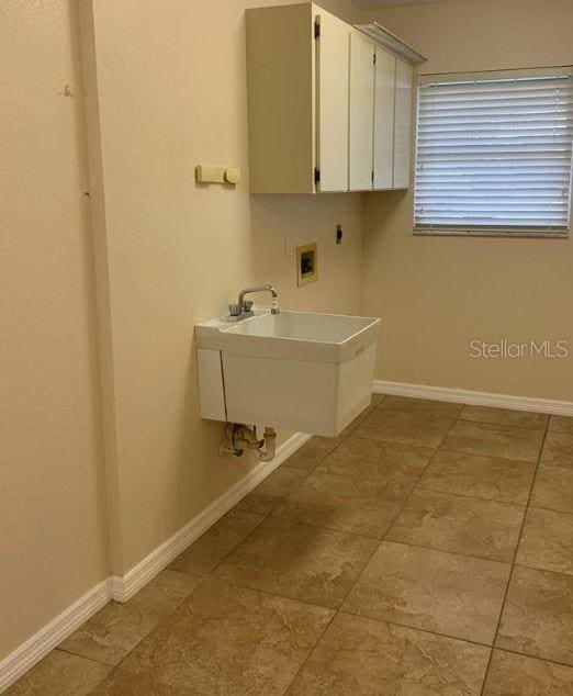 2178 Calcutta Rd, Punta Gorda, FL 33983 - clothes washing area featuring hookup for a washing machine, electric dryer hookup, baseboards, and cabinet space