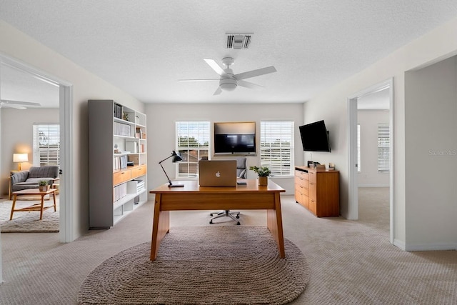 4429 67th St E, Bradenton, FL 34203 - home office featuring a ceiling fan, light carpet, baseboards, and a textured ceiling
