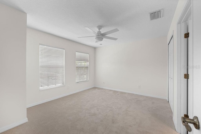 4429 67th St E, Bradenton, FL 34203 - unfurnished bedroom with light carpet, baseboards, a textured ceiling, and ceiling fan