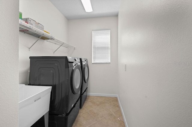 4429 67th St E, Bradenton, FL 34203 - laundry room with separate washer and dryer, baseboards, and light tile patterned flooring