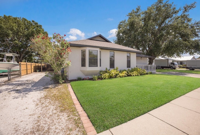 view of front of house with stucco siding, driveway, and a shingled roof