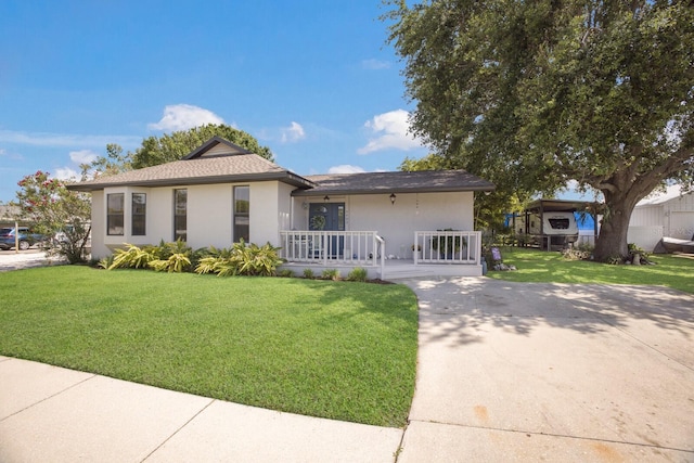 view of front of home with a porch, stucco siding, a front lawn, concrete driveway, and a shingled roof