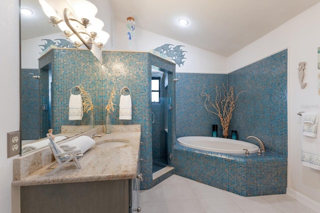 bathroom with a stall shower, tile patterned flooring, a garden tub, vanity, and lofted ceiling