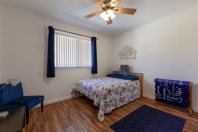 bedroom featuring wood finished floors, baseboards, and ceiling fan